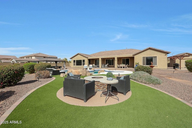 rear view of property featuring a gazebo, a patio area, an outdoor living space with a fire pit, and stucco siding