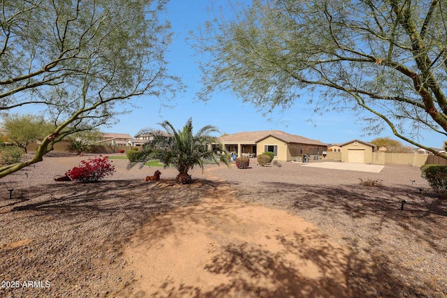 view of front of property with concrete driveway and fence