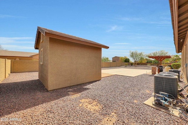 view of yard featuring a fenced backyard, central AC, and a patio