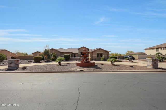 view of front of property featuring a residential view and concrete driveway