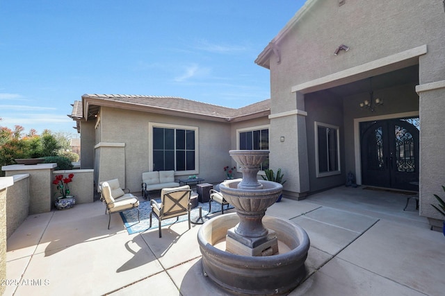 view of patio / terrace with french doors and an outdoor living space