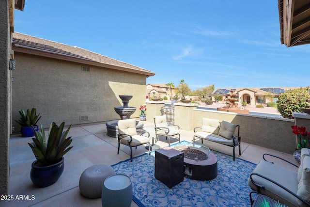 view of patio / terrace featuring visible vents and an outdoor living space with a fire pit