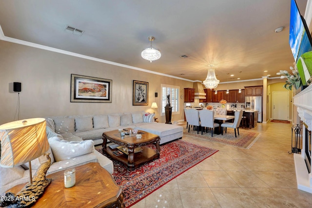 living area featuring an inviting chandelier, visible vents, crown molding, and light tile patterned flooring