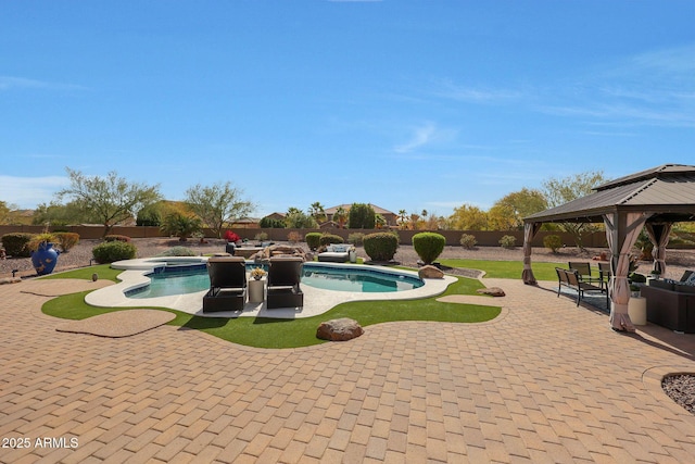 view of pool featuring a fenced in pool, a patio, a fenced backyard, an in ground hot tub, and a gazebo