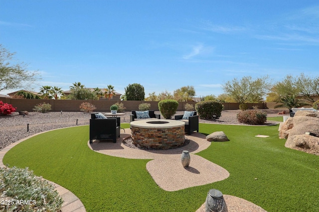 view of yard with a patio area, a fenced backyard, and a fire pit