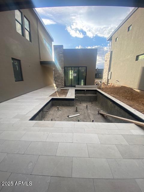 view of swimming pool featuring french doors and a patio area