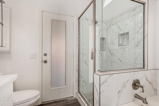full bathroom with a marble finish shower, toilet, vanity, a tub to relax in, and wood finished floors