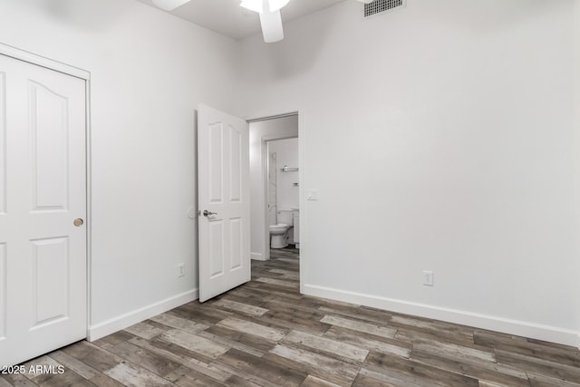 unfurnished bedroom featuring wood finished floors, baseboards, and ceiling fan