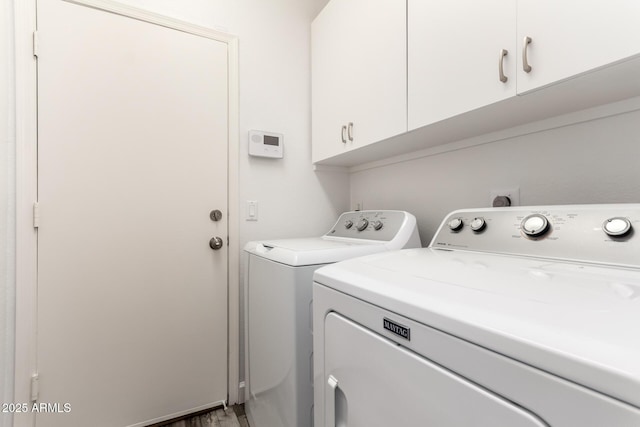 laundry room with washer and dryer and cabinet space