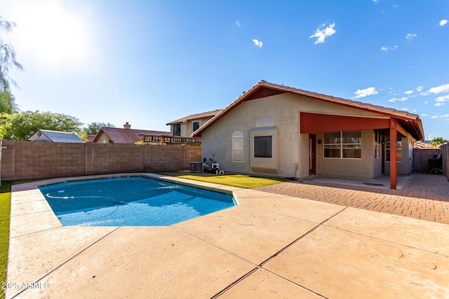 view of swimming pool with a patio and a fenced backyard
