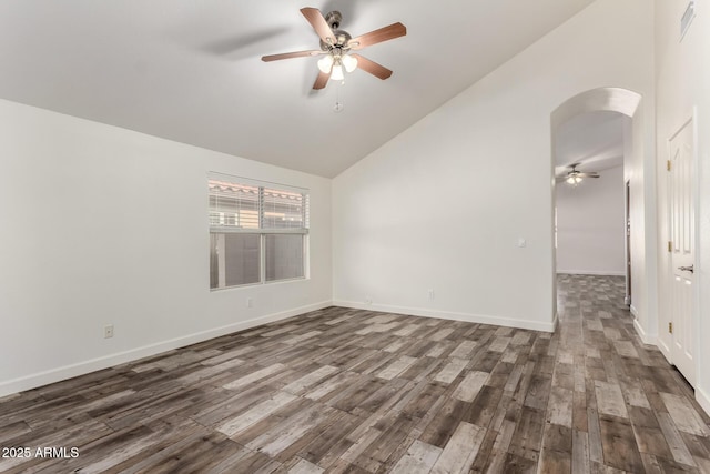 spare room featuring arched walkways, ceiling fan, high vaulted ceiling, wood finished floors, and baseboards