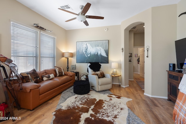 living room with ceiling fan and light wood-type flooring