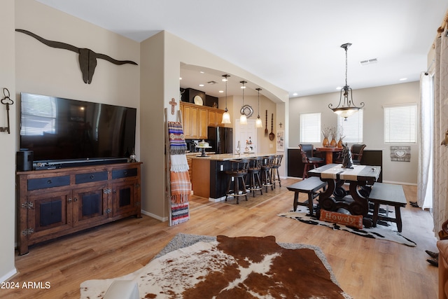 dining room featuring sink and light hardwood / wood-style floors