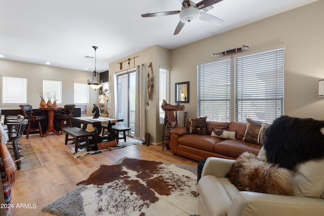 living room with ceiling fan and light hardwood / wood-style floors