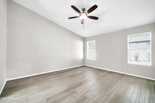 unfurnished room featuring ceiling fan, baseboards, wood finished floors, and lofted ceiling