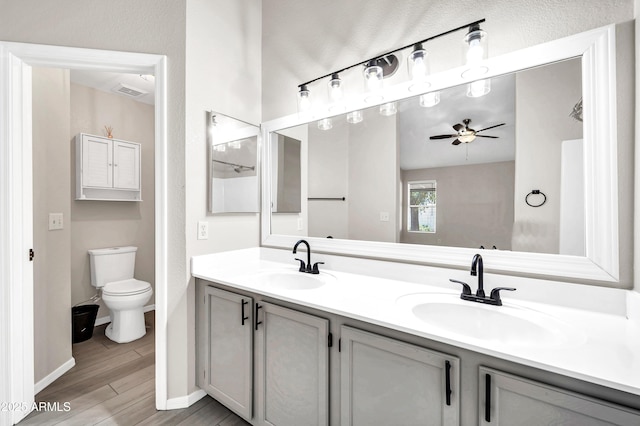 full bathroom with double vanity, visible vents, a sink, and ceiling fan
