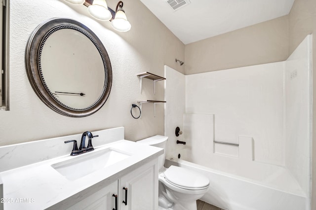 bathroom featuring vanity, a textured wall, bathing tub / shower combination, toilet, and visible vents