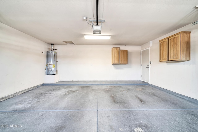 garage with a garage door opener and gas water heater