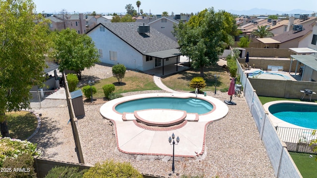 view of pool with a fenced backyard, a fenced in pool, a residential view, and cooling unit
