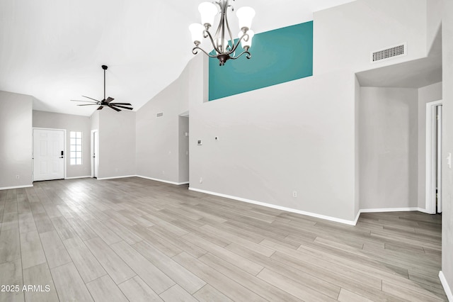 unfurnished living room featuring visible vents, high vaulted ceiling, wood finished floors, and ceiling fan with notable chandelier