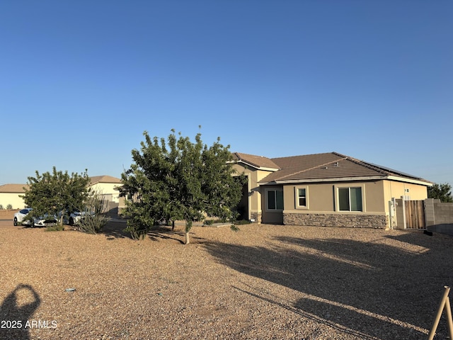 9759 E Brown Rd, Mesa, AZ 85207 - rear view of house featuring stone siding, stucco siding, and a tiled roof