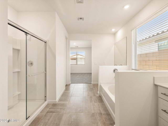 full bath with a stall shower, visible vents, a garden tub, and vanity