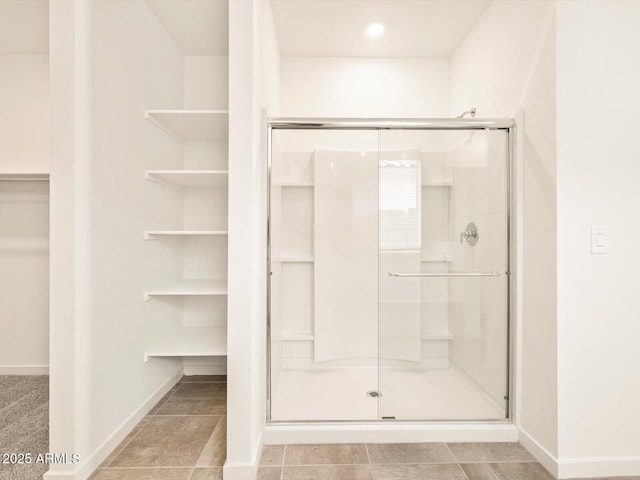 full bath featuring recessed lighting, baseboards, a spacious closet, and a stall shower