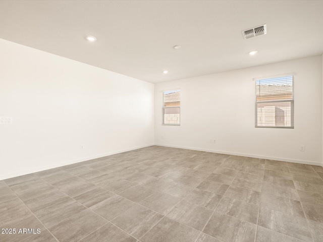 empty room featuring plenty of natural light and recessed lighting