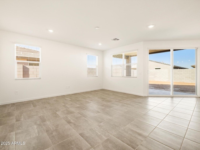 unfurnished room with recessed lighting, baseboards, and light tile patterned flooring