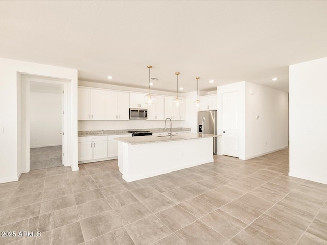 kitchen with a sink, appliances with stainless steel finishes, white cabinets, and recessed lighting
