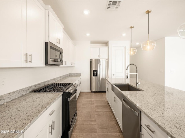 kitchen featuring visible vents, a sink, white cabinets, and stainless steel appliances