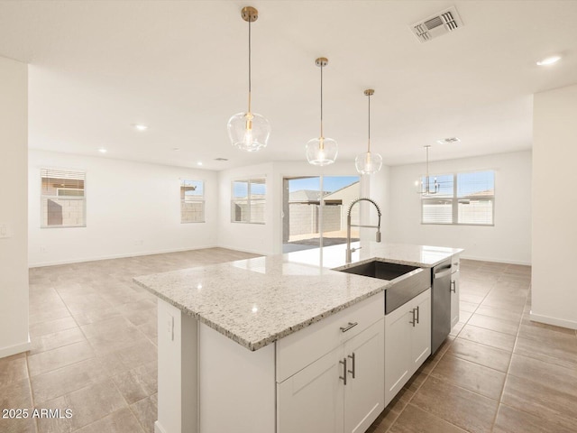kitchen featuring hanging light fixtures, a sink, a kitchen island with sink, stainless steel dishwasher, and visible vents