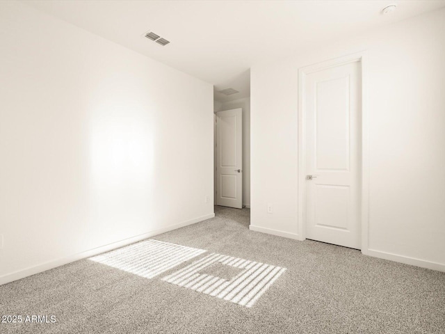 unfurnished bedroom with visible vents, carpet, and baseboards