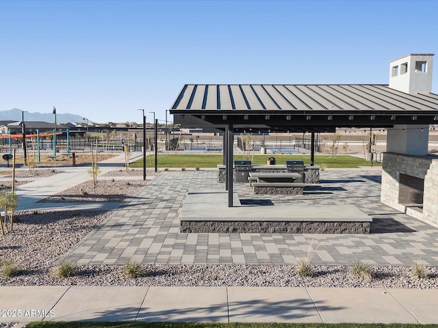 surrounding community with a mountain view and a gazebo