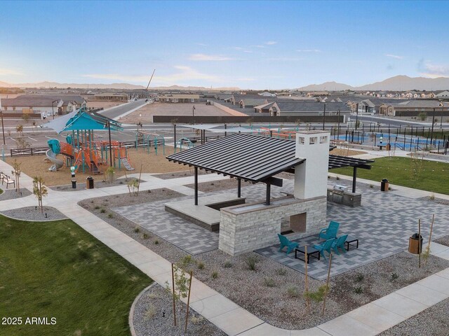 view of community with a playground and a mountain view