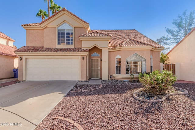 mediterranean / spanish house featuring a garage, fence, concrete driveway, a tiled roof, and stucco siding