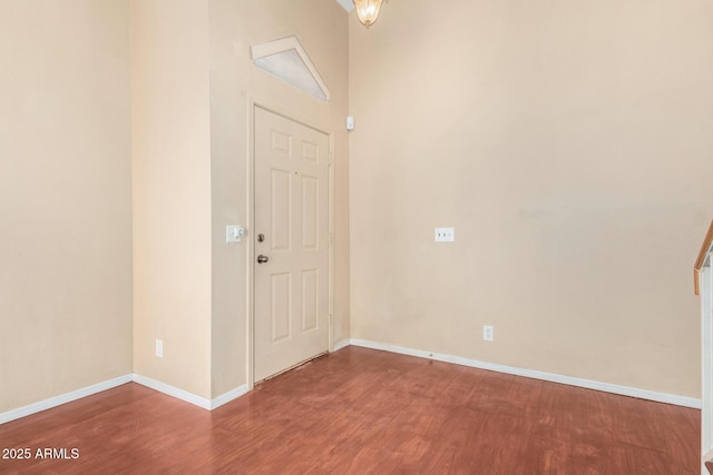 entryway featuring baseboards and wood finished floors