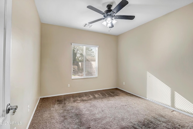 empty room featuring ceiling fan and carpet