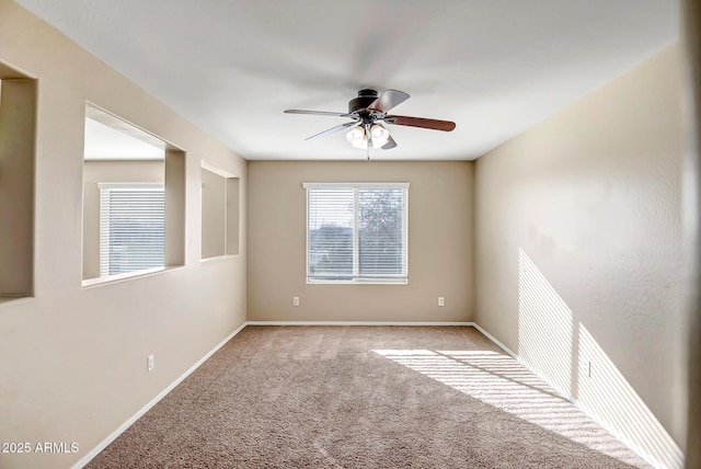 carpeted spare room with ceiling fan