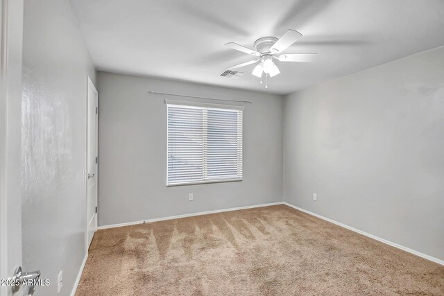 empty room with ceiling fan and carpet floors