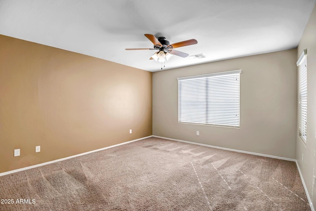 unfurnished room featuring ceiling fan, carpet floors, and a healthy amount of sunlight