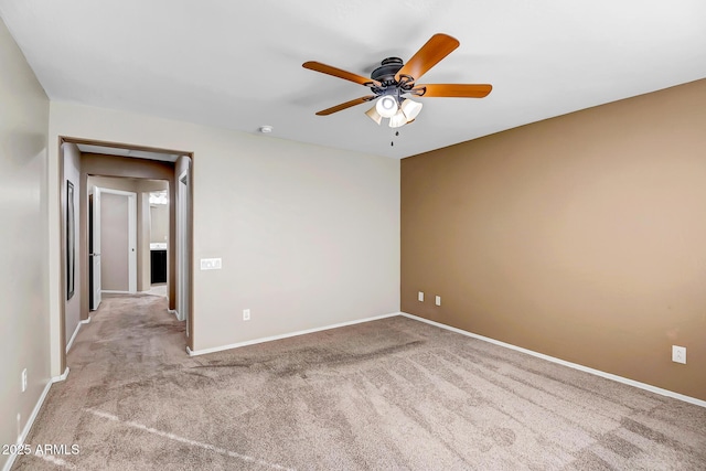 carpeted spare room with ceiling fan