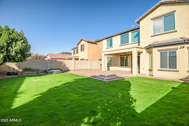 rear view of property featuring a lawn and a patio