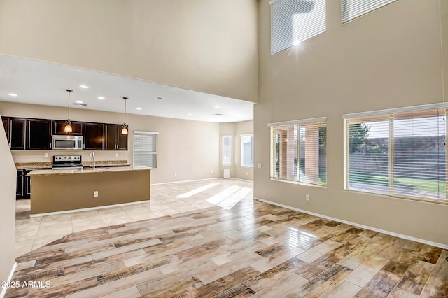 unfurnished living room featuring sink and a high ceiling