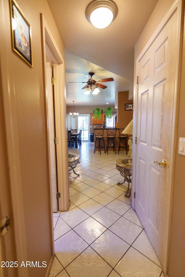 111 N Soho Pl, Chandler, AZ 85225 - hallway featuring light tile patterned floors, a chandelier, and vaulted ceiling
