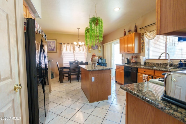 111 N Soho Pl, Chandler, AZ 85225 - kitchen featuring black appliances, a chandelier, a kitchen island, light tile patterned flooring, and hanging light fixtures