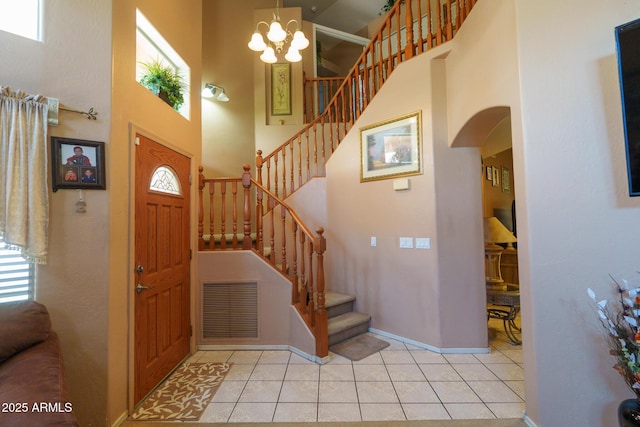 111 N Soho Pl, Chandler, AZ 85225 - entrance foyer with a high ceiling, stairway, arched walkways, healthy amount of natural light, and light tile patterned floors