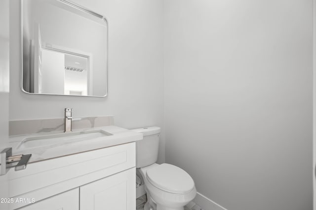 bathroom featuring visible vents, vanity, and toilet