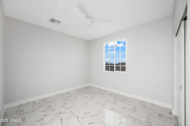 unfurnished bedroom featuring marble finish floor, visible vents, baseboards, and a closet