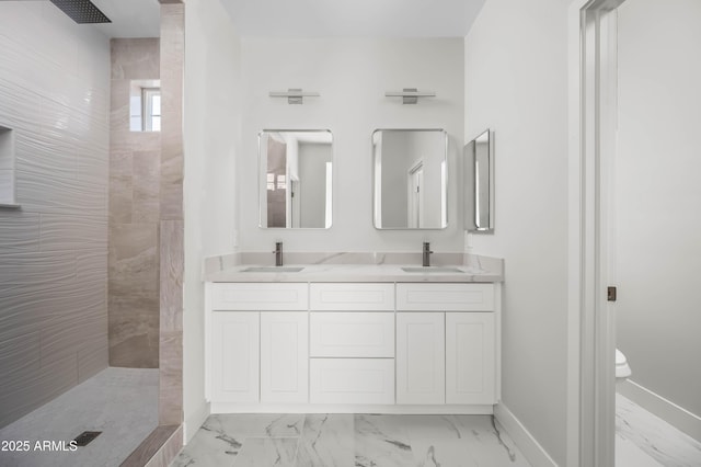 full bath featuring marble finish floor, walk in shower, and a sink